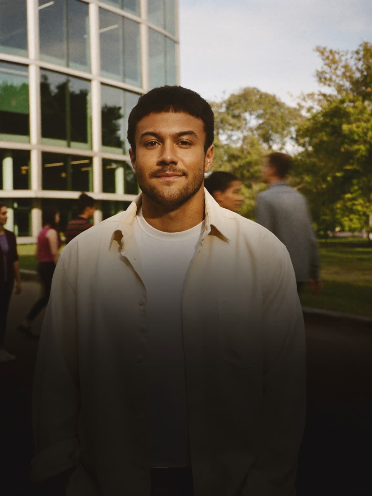 A young founder on campus at golden hour